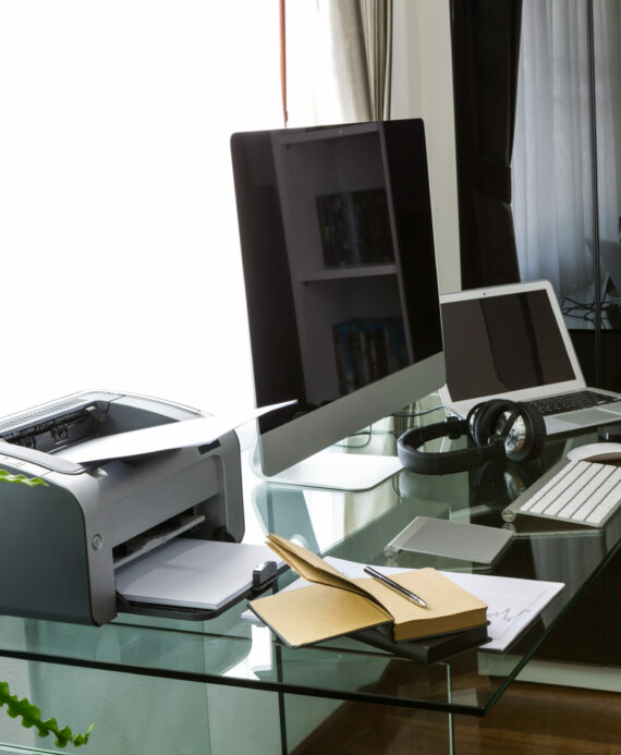 Modern home office with computer and laptop